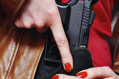 woman pulling handgun from holdster